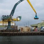An image of an excavator working on a port.