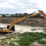 An image of a long reach excavator at work on river bank