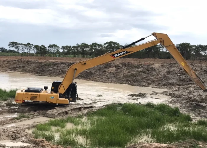 An image of a long reach excavator at work on river bank