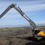 Image of a volvo long reach excavator working a site